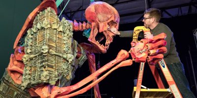 Set Dresser Andy Berry works on the massive Hall of Bones Skeleton
